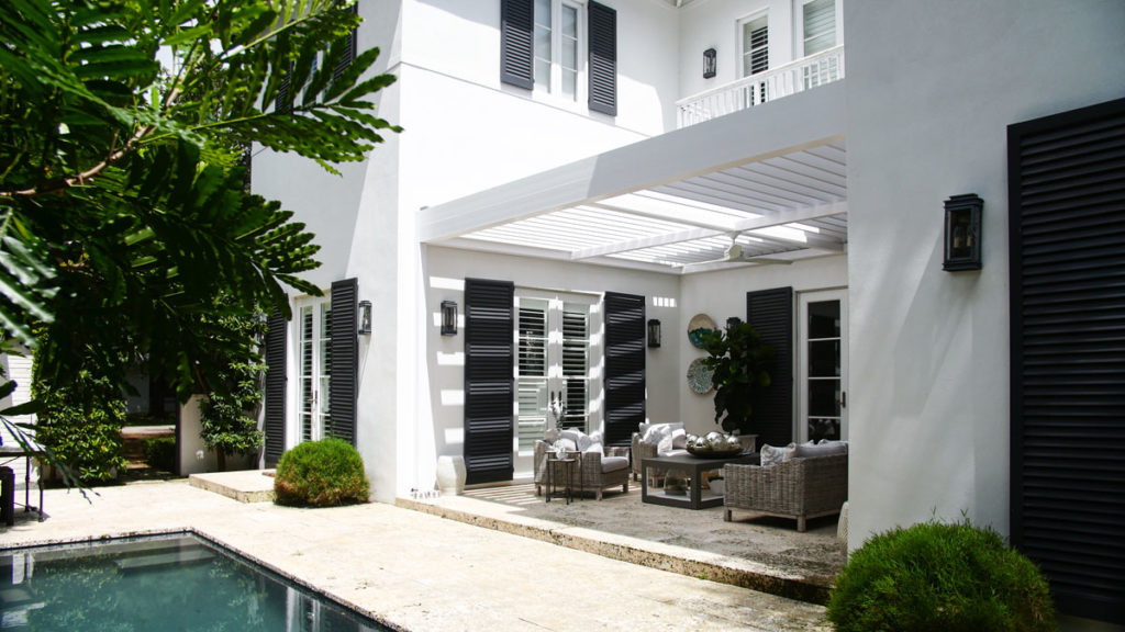 Traditional French style house with covered patio - louvered pergola system - South Florida