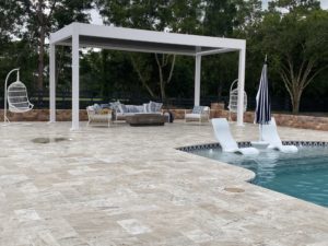 pool deck with white pergola