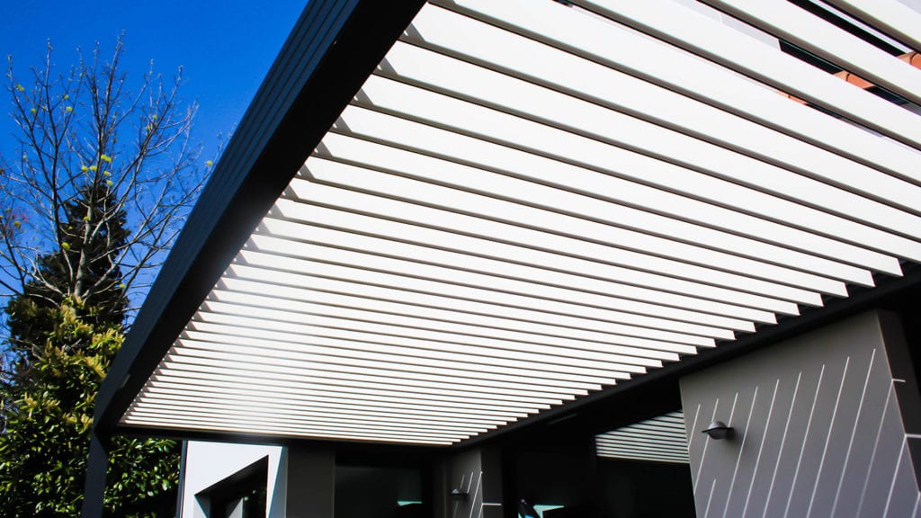 Grey and white louvered roof pergola