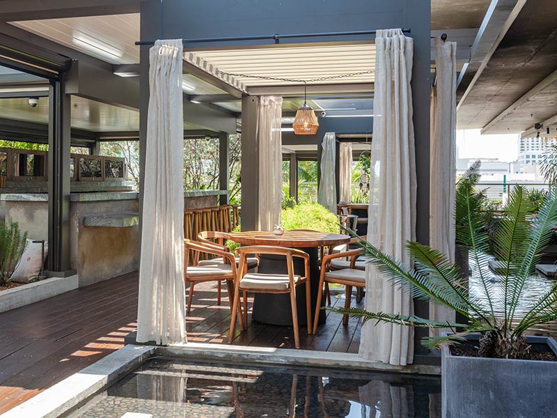 louvered pergola with curtain at the exterior