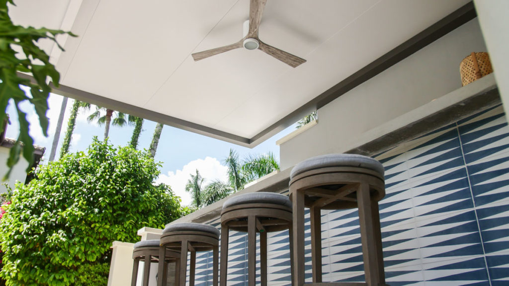 outdoor bar under a pergola with fan
