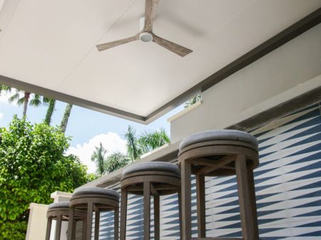 outdoor bar under a pergola with fan