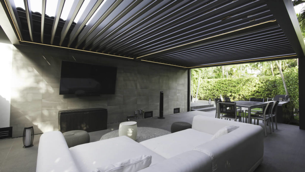 Louvered pergola to create a outdoor TV room