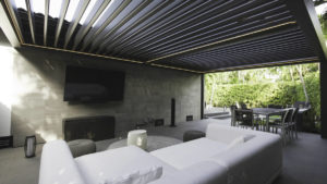Louvered pergola to create a outdoor TV room