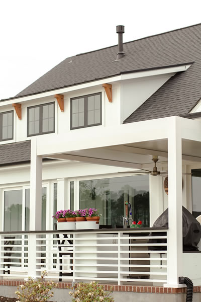 fixed roof pergola in white to protect an outdoor kitchen
