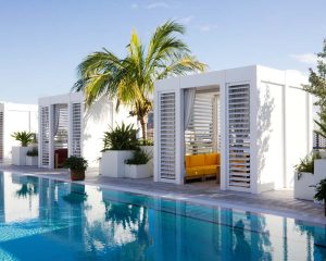 Commercial pergola by Azenco: Aluminum cabana with solid roofs and louvered panels - Arlo Hotel Miami