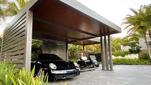 Azenco custom carport for luxury cars and golf carts, featuring bronze frame and wood grain finish insulated roof - Azenco outdoor