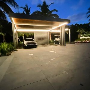 Azenco car port by night with led light on and black Porsche car.