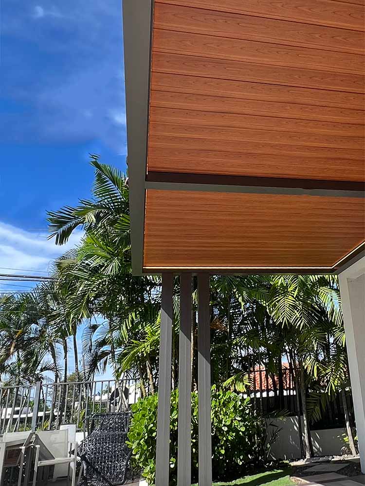 Wood finish louvers and black aluminum frame. R-Blade pergola by Azenco in Puerto Rico