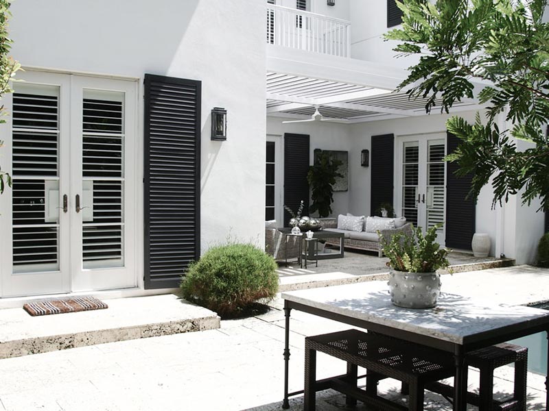 All white classic renaissance outdoor patio with modern pergola.