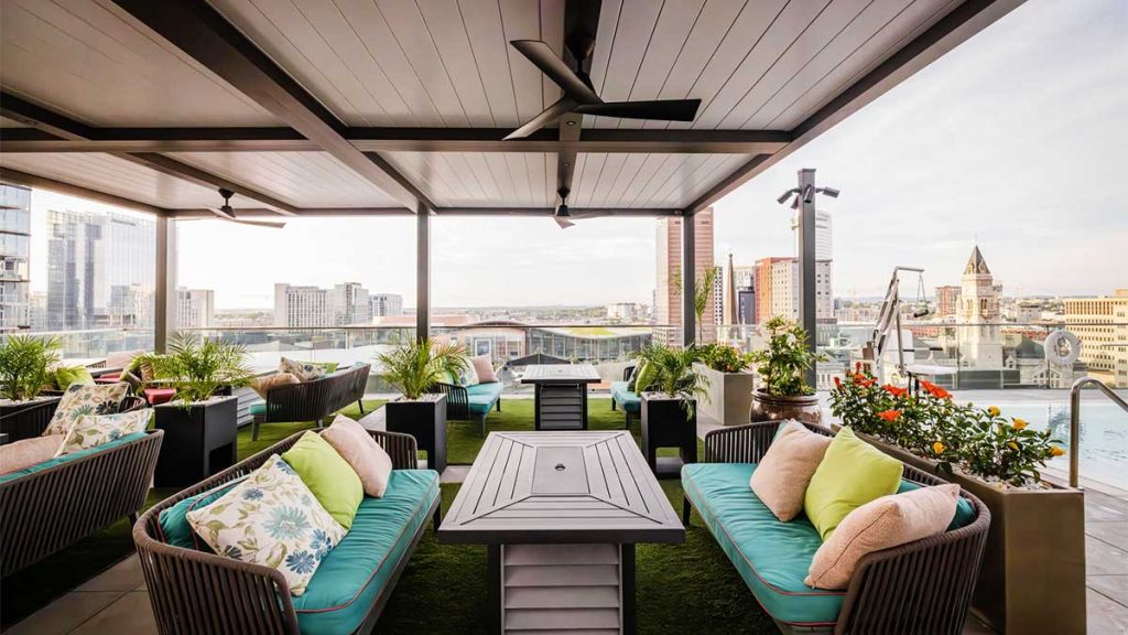 covered outdoor dining at a hotel rooftop area - covered pool deck area for guests - pergolawith fan