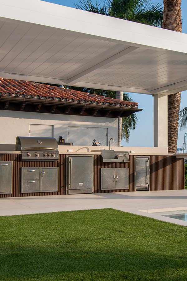 outdoor kitchen and Modern louvered pergola in Miami Beach
