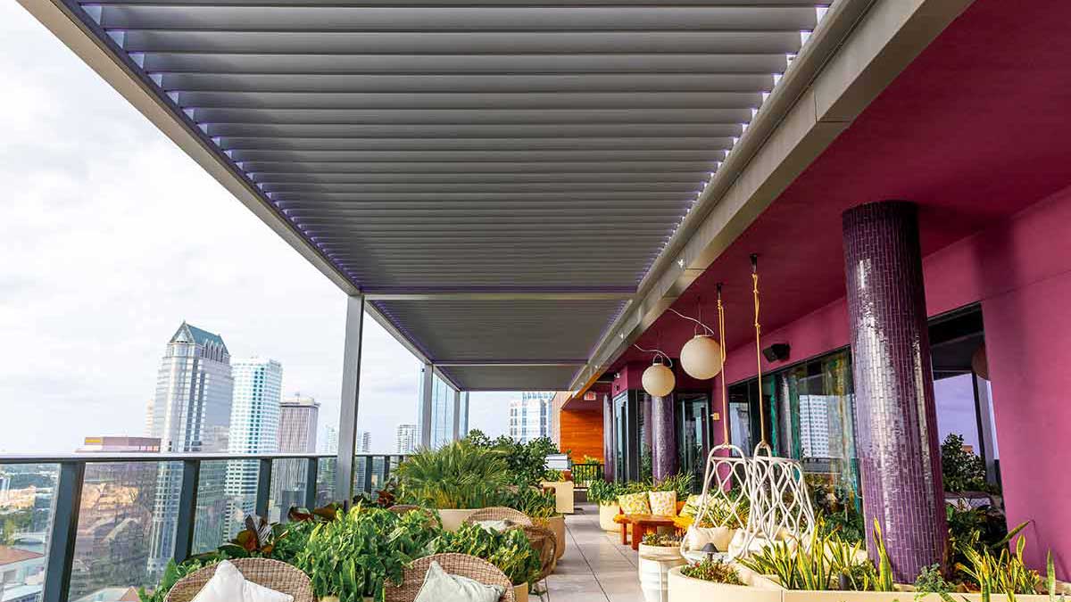 Hotel rooftop terrace with pergola system by Azenco