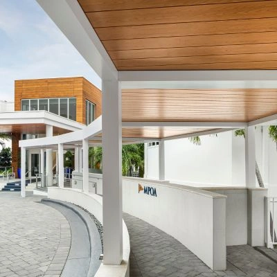 Custom crafted commercial shade structures with white frame and wood grain finish roof for a country club - Azenco Outdoor