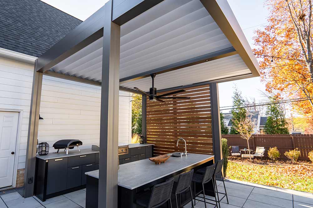 The pergola, cabinetry, and privacy features have all combined to create an inviting space that is functional, comfortable, and elegant. Azenco Outdoor