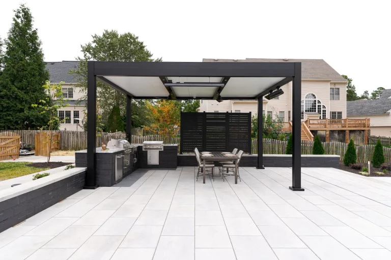 This photo shows an R-Shade in a backyard. The R-Shade provides shade for an outdoor kitchen.