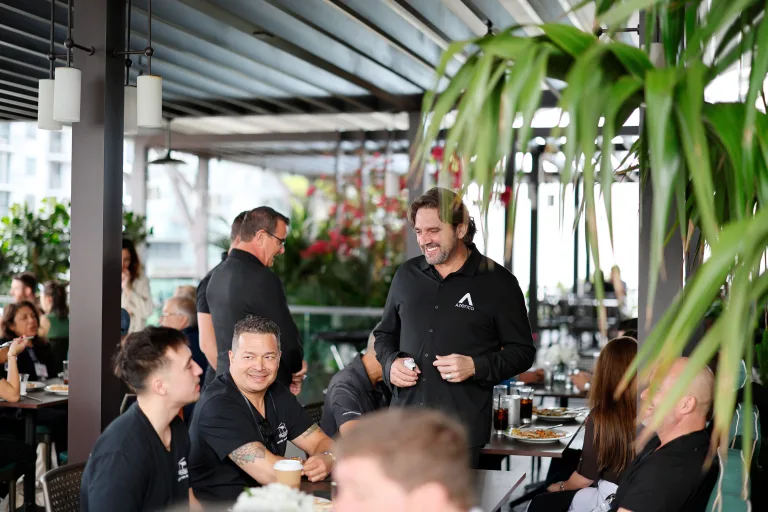 Charles Chapus, CEO, speaking with a dealer during lunch