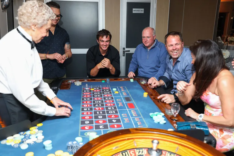 a group of people around a roulette table