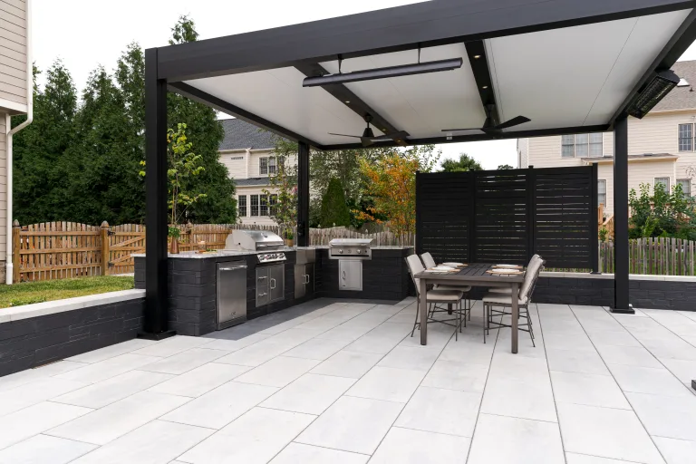 black r-shade with an outdoor kitchen in a backyard