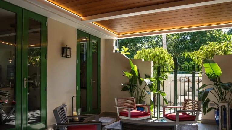 white r-blade with a wooden roof attached to a house patio