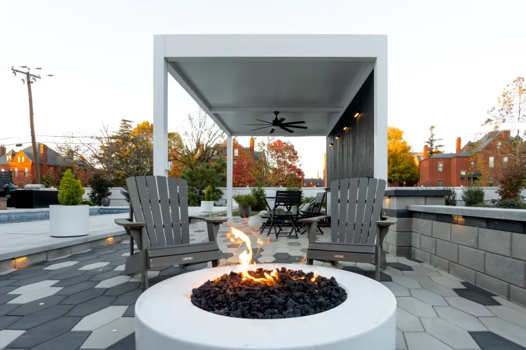 white r-shade in a backyard with outdoor furniture and a fire pit