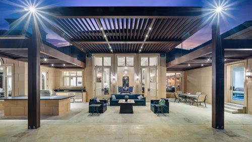 Luxury outdoor dining space covered with 3 louvered pergola