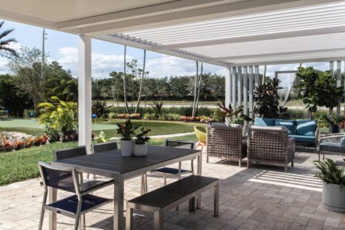 outdoor dining space civered with louvered roof and fixed roof