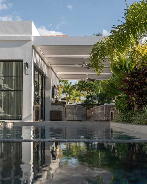 Attached to the house custom louvered roof pergola in full white by Azenco