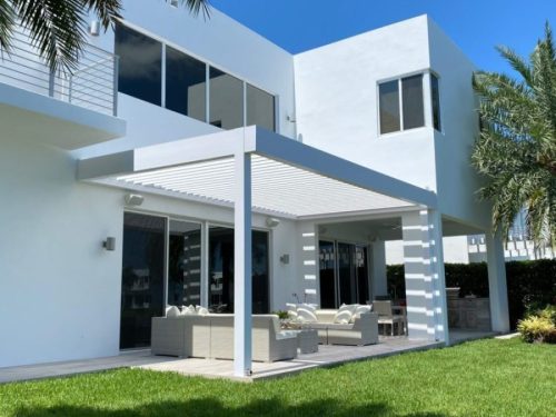 outdoor structure, wall-mounted pergola in white with motorized louvered roof - hurricane zone