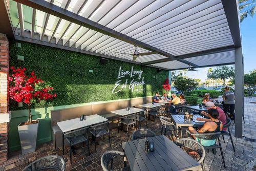 Restaurant covered outdoor space: Motorized louvered pergola by Azenco