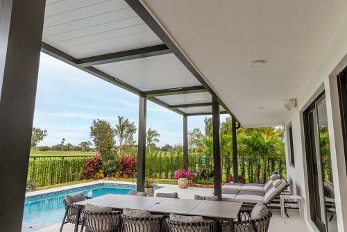 Automated louvered roof attachded to the wall: Patio cover extension with R-BLADE pergola by Azenco Outdoor