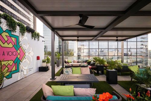 Louvered pergola and fan on hotel rooftop terrace - Azenco Outdoor