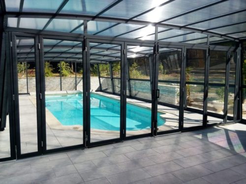 Pool cover enclosure with doors