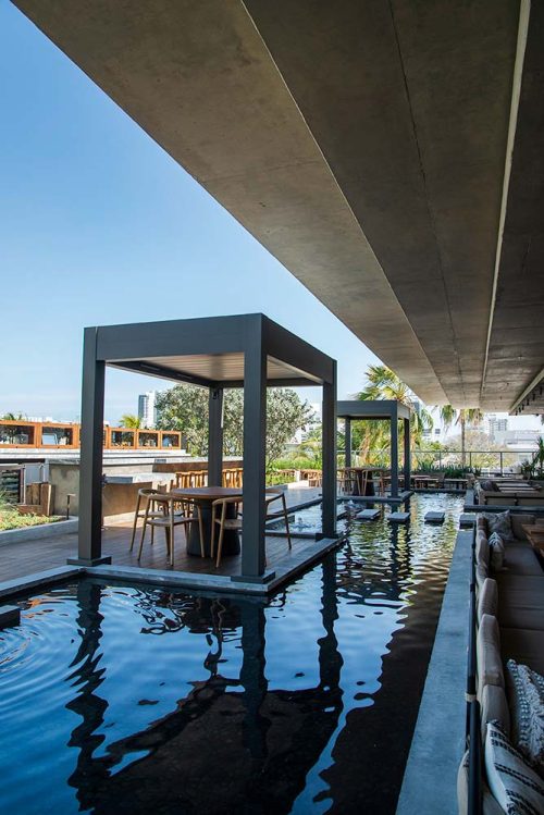 Dining covered islands on resaturant rooftop terrace - R-BLADE pergolas by Azenco Outdoor