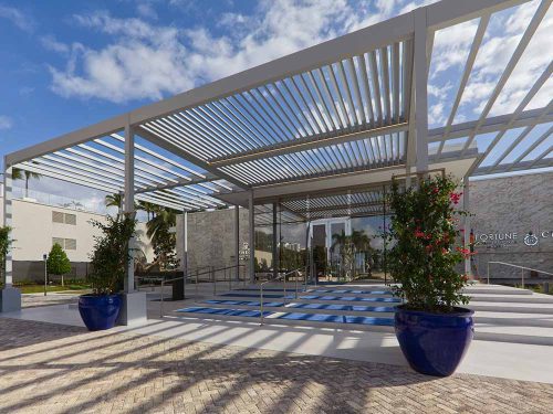 Townhall covered entrance: R-BREEZE pergoal with fixed louverd roof -Azenco
