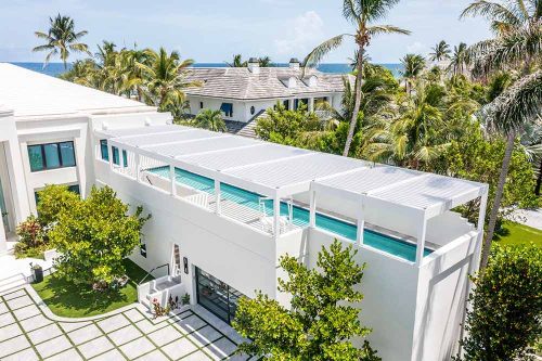 Luxury rooftop pool cover in white: Custom electric pergola system in South Florida by Azenco Outdoor