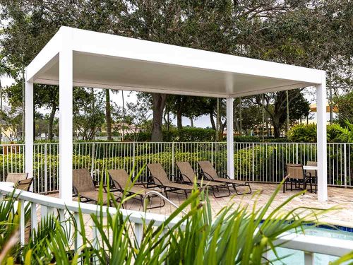 White aluminum pergola with premium insulated sandwich panels for a community pool - Azenco Outdoor
