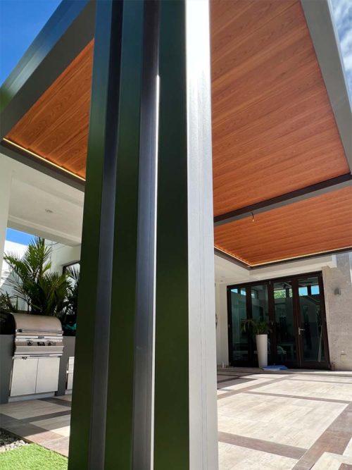 Black frame and wood finish automated louvers. R-Blade pergola by Azenco in Puerto Rico